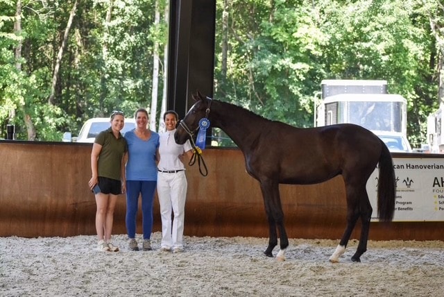 Three people with a yearling colt at Crescent Moon Farm